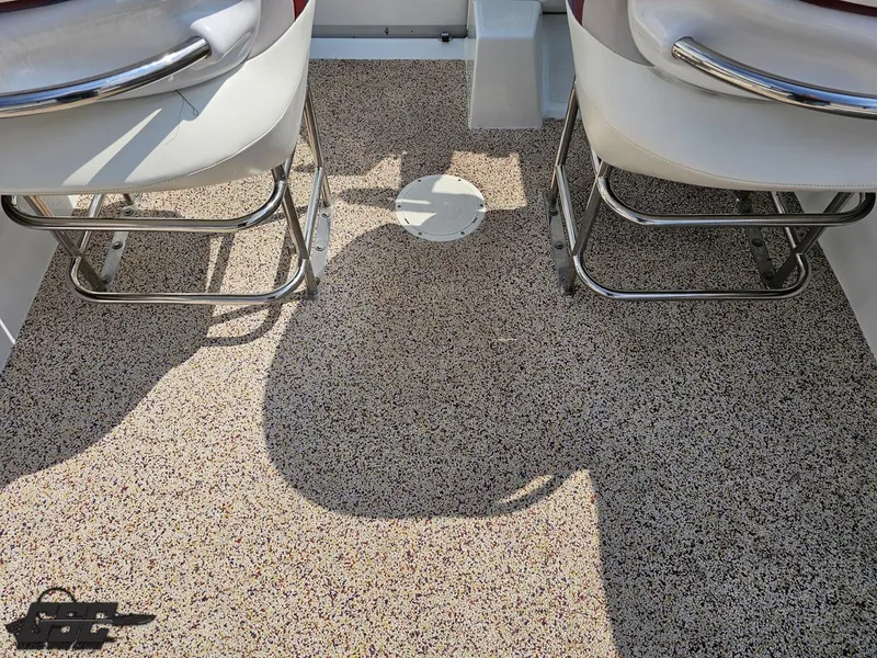 Slide: The Image of 2007 Baja 35 Outlaw boat interior with speckled flooring and white seats. - 47