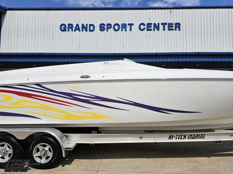 Slide: The Image of 2007 Baja 35 Outlaw boat with colorful graphics at Grand Sport Center. - 5