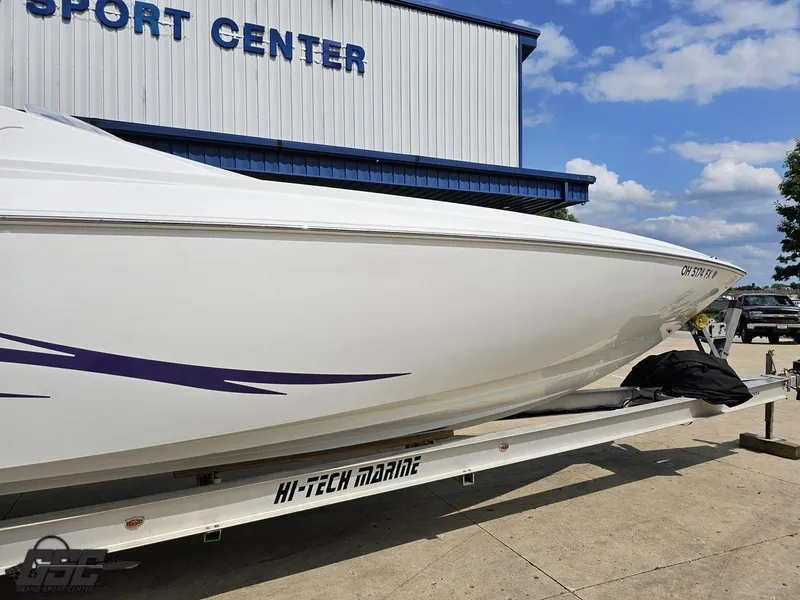 Slide: The Image of 2007 Baja 35 Outlaw boat on trailer at sport center, clear sky background. - 6