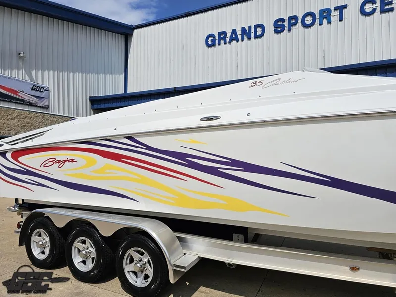 Slide: The Image of 2007 Baja 35 Outlaw boat with colorful graphics at Grand Sport Center. - 7