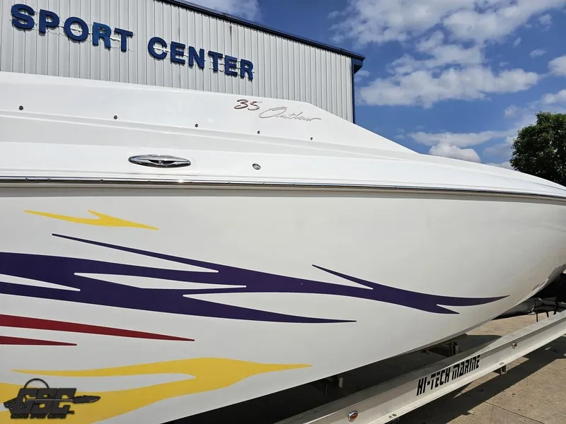 Slide: The Image of 2007 Baja 35 Outlaw boat with colorful graphics at a sport center. - 9