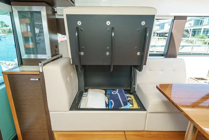Slide: The Image of Interior of 2016 Tiara Yachts C44 Coupe with under-seat storage open. - 24