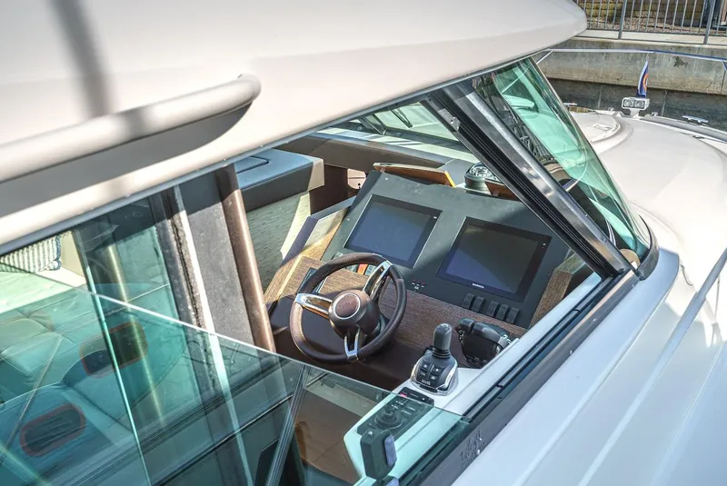 Slide: The Image of 2016 Tiara Yachts C44 Coupe helm with modern navigation displays and controls. - 31