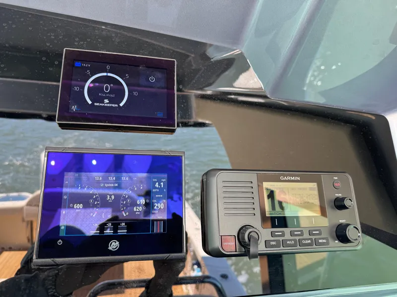 Slide: The Image of Control panel of 2023 Chris-Craft Calypso 35 with Seakeeper and Garmin displays. - 10