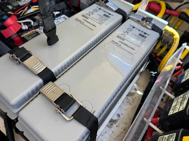 Slide: The Image of Battery compartment of 2023 Chris-Craft Calypso 35 with secured power units and wiring. - 12