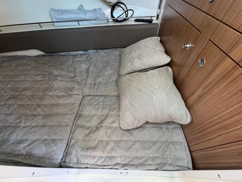 Slide: The Image of 2023 Chris-Craft Calypso 35 cabin interior with bed and wooden cabinetry. - 13