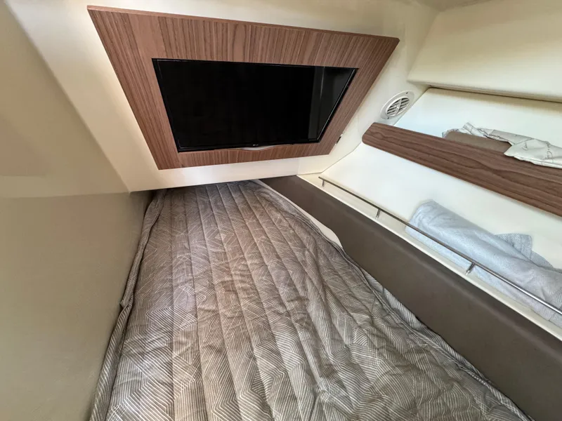 Slide: The Image of 2023 Chris-Craft Calypso 35 cabin interior with bed and wall-mounted TV. - 14