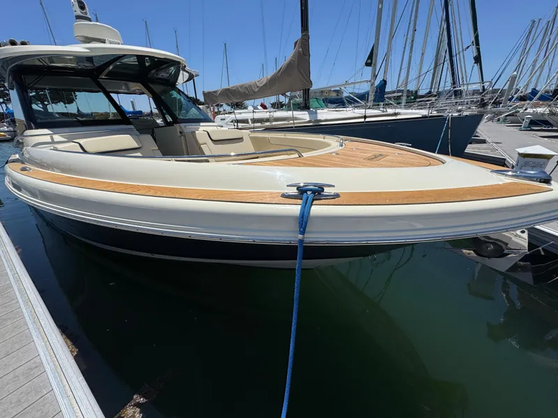 Slide: The Image of 2023 Chris-Craft Calypso 35 boat docked at marina, showcasing sleek design and luxury features. - 15