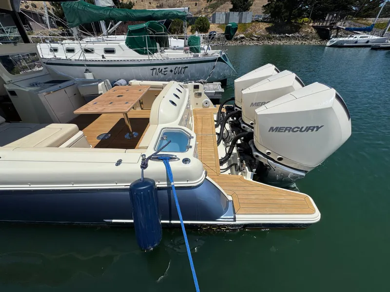 Slide: The Image of 2023 Chris-Craft Calypso 35 with Mercury engines docked in a marina. - 16