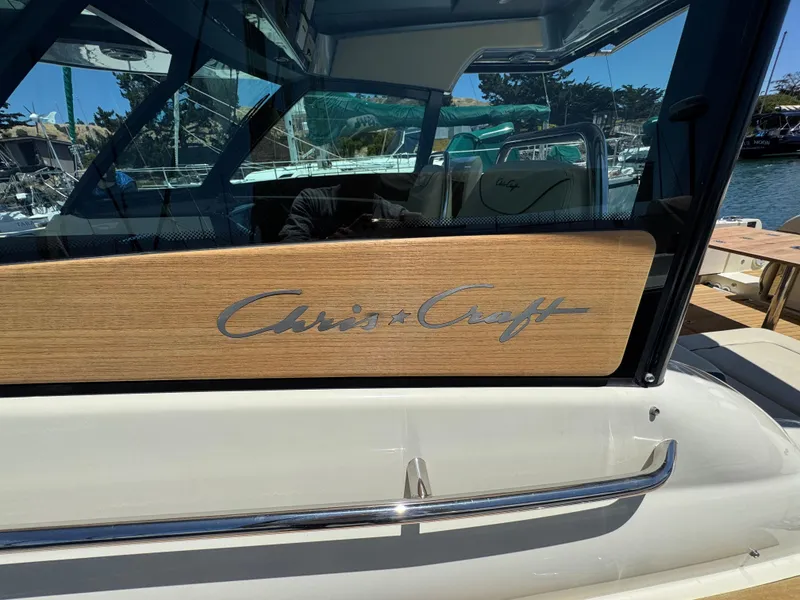 Slide: The Image of 2023 Chris-Craft Calypso 35 boat with wooden panel and logo detail. - 19
