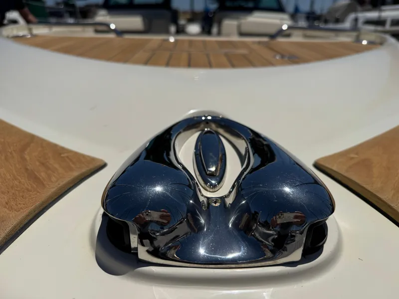 Slide: The Image of 2023 Chris-Craft Calypso 35 boat with polished chrome detail and wooden deck. - 21