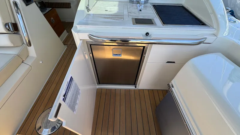 Slide: The Image of 2023 Chris-Craft Calypso 35 boat interior with kitchenette and stainless steel appliances. - 27