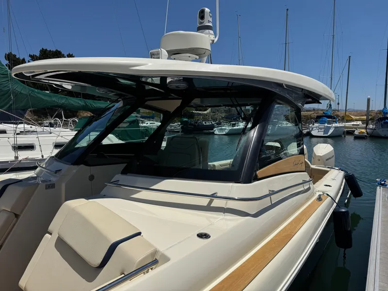 Slide: The Image of 2023 Chris-Craft Calypso 35 boat docked in a marina, showcasing sleek design. - 28