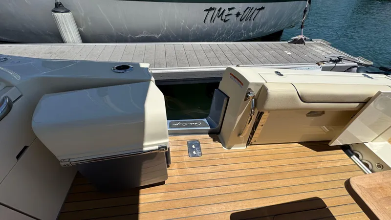 Slide: The Image of 2023 Chris-Craft Calypso 35 boat interior with teak flooring and dock view. - 29
