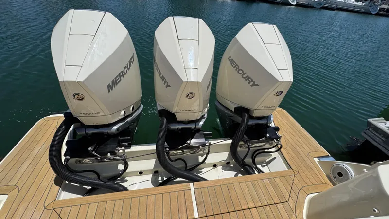 Slide: The Image of Triple Mercury Verado engines on 2023 Chris-Craft Calypso 35 boat, docked on water. - 35