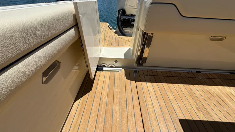 Slide: The Image of 2023 Chris-Craft Calypso 35 boat deck with open door, showcasing teak flooring. - 36