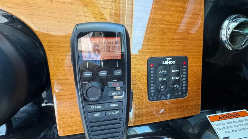 Slide: The Image of Control panel of 2023 Chris-Craft Calypso 35 with radio and Lenco trim tab switches. - 41