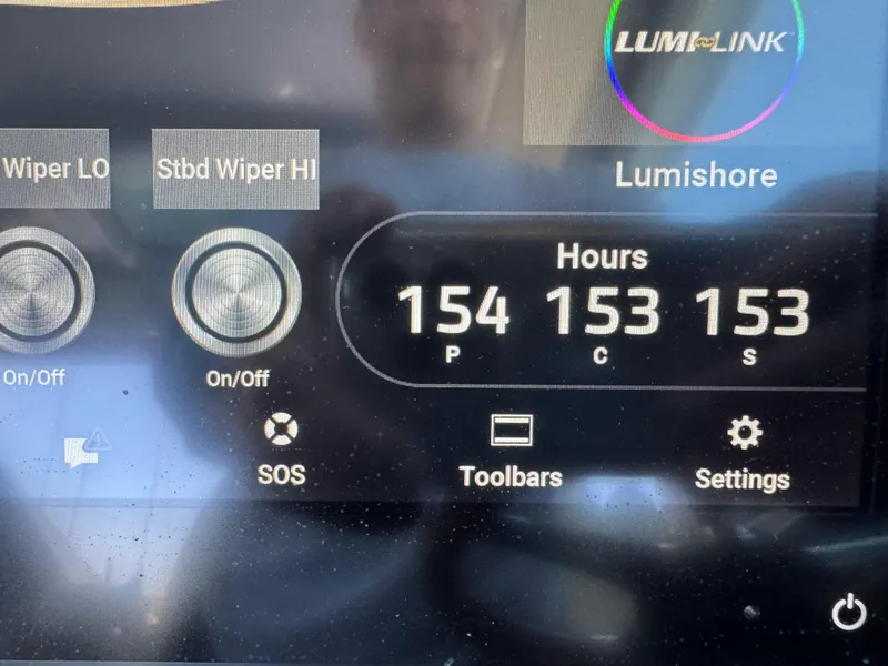 Slide: The Image of 2023 Chris-Craft Calypso 35 dashboard display showing wiper controls and engine hours. - 46