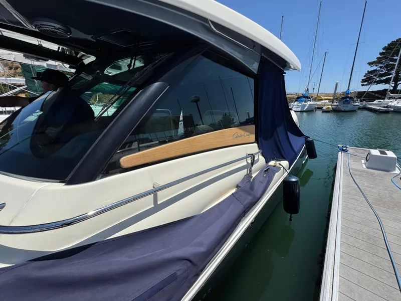Slide: The Image of 2023 Chris-Craft Calypso 35 docked at marina, side view with protective cover. - 49
