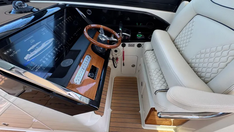 Slide: The Image of 2023 Chris-Craft Calypso 35 helm with luxury seating and advanced navigation display. - 5