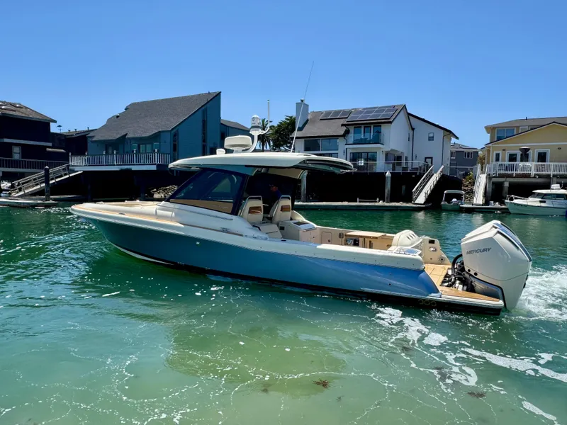 Slide: The Image of 2023 Chris-Craft Calypso 35 boat cruising in a sunny waterfront setting. - 6