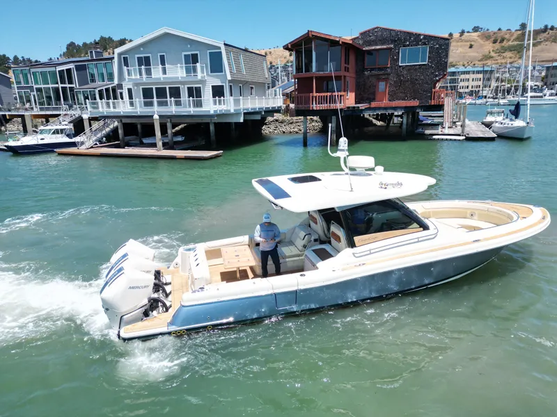 Slide: The Image of 2023 Chris-Craft Calypso 35 boat cruising near waterfront homes. - 7