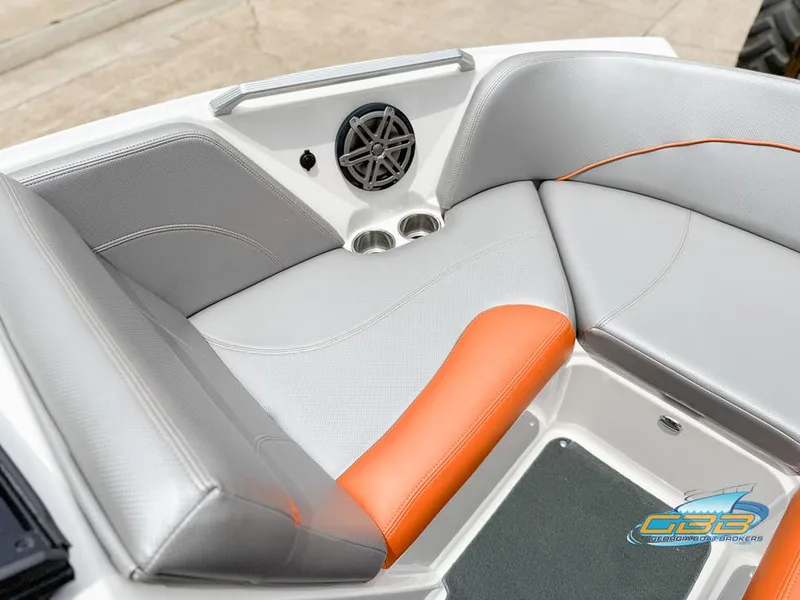 Slide: The Image of 2017 MasterCraft XT20 boat interior with gray and orange seating, speaker, and cup holders. - 11