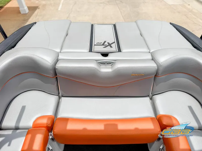 Slide: The Image of 2017 MasterCraft XT20 boat interior with gray and orange seating. - 12