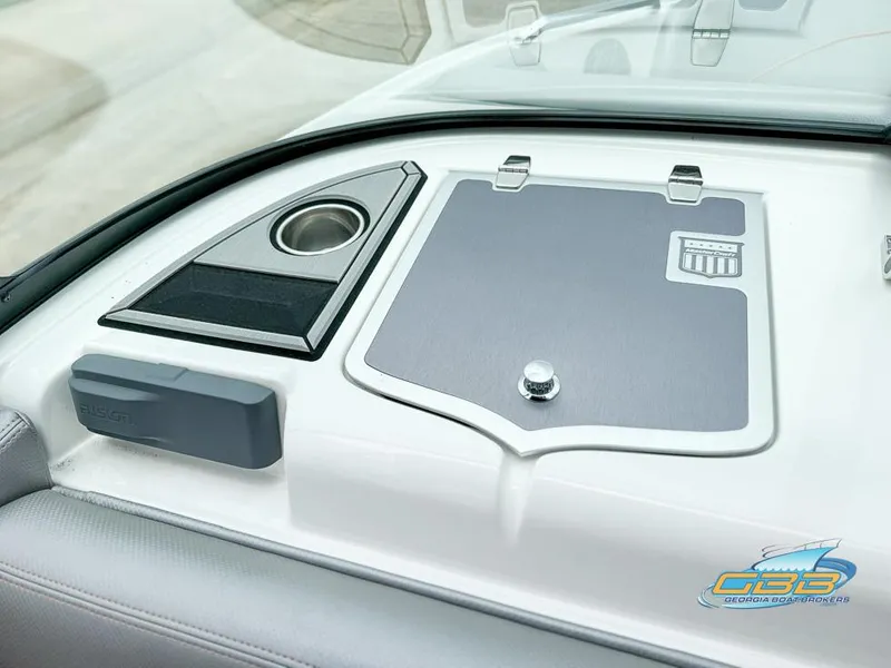 Slide: The Image of 2017 MasterCraft XT20 dashboard with cup holder and storage compartment. - 21
