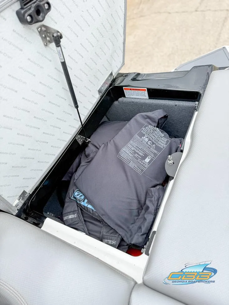 Slide: The Image of Storage compartment in a 2017 MasterCraft XT20 boat with life jackets inside. - 29