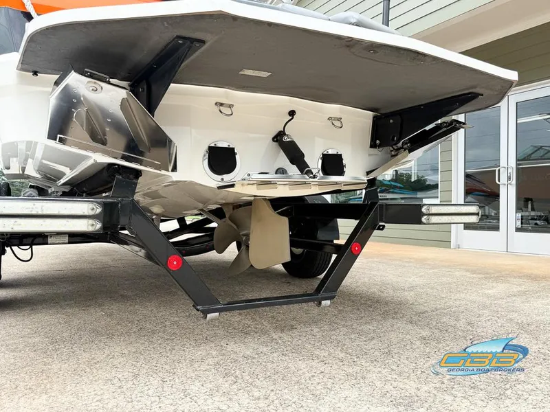 Slide: The Image of 2017 MasterCraft XT20 boat on trailer, rear view showing propeller and hull details. - 6