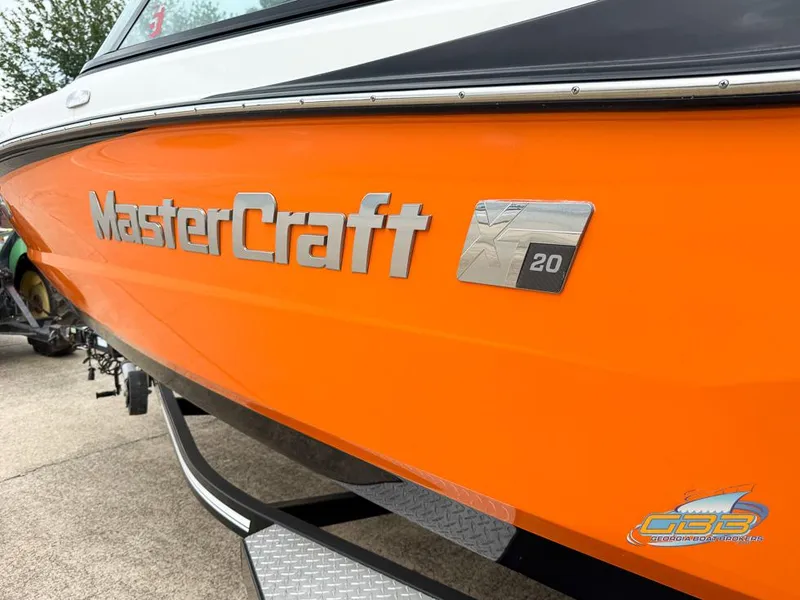 Slide: The Image of 2017 MasterCraft XT20 boat with vibrant orange exterior and logo detailing. - 8
