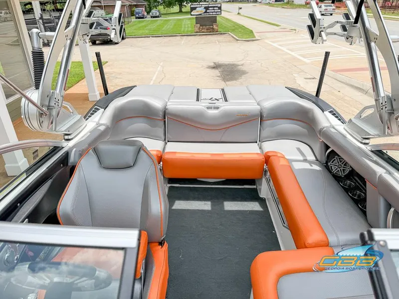 Slide: The Image of 2017 MasterCraft XT20 boat interior with orange and gray seating, featuring modern design and spacious layout. - 9