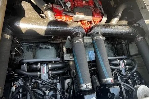 Slide: The Image of Engine compartment of a 2000 Sea Ray 310 Sundancer boat, showcasing dual engines. - 11