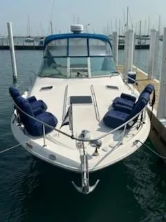 Slide: The Image of 2000 Sea Ray 310 Sundancer docked, featuring blue seating and sleek design. - 12