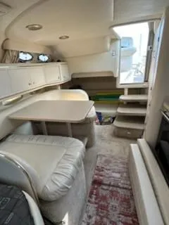 Slide: The Image of Interior of 2000 Sea Ray 310 Sundancer yacht with seating and table. - 5