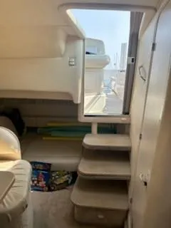 Slide: The Image of Interior view of 2000 Sea Ray 310 Sundancer yacht with stairs and seating area. - 7