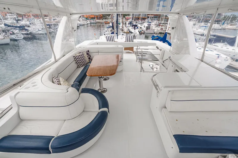 Slide: The Image of Luxurious 1999 Horizon 70 Motor Yacht interior with elegant seating and marina view. - 11