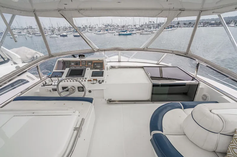 Slide: The Image of Helm of 1999 Horizon 70 Motor Yacht with marina view in background. - 12