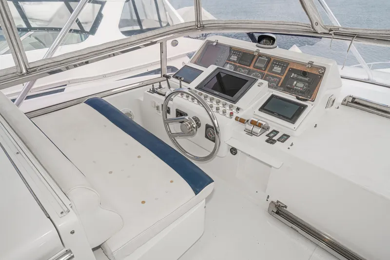Slide: The Image of Cockpit of 1999 Horizon 70 Motor Yacht with steering wheel and navigation controls. - 14