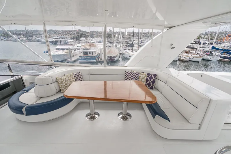 Slide: The Image of Luxurious 1999 Horizon 70 Motor Yacht interior with elegant seating and marina view. - 17