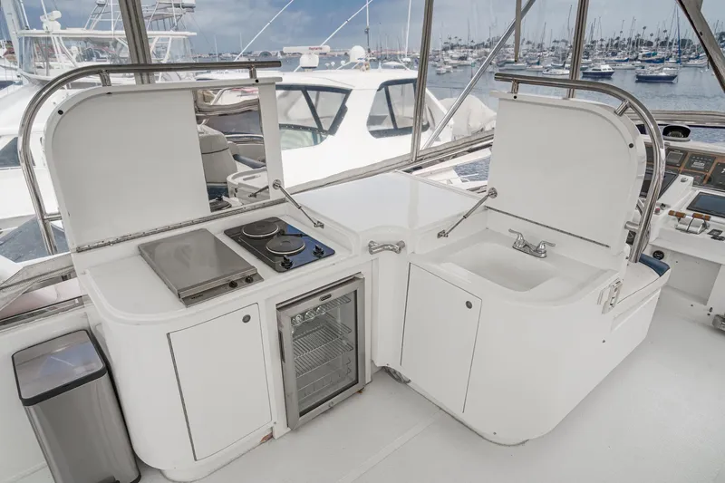 Slide: The Image of Outdoor kitchen on 1999 Horizon 70 Motor Yacht with stove, sink, and mini fridge. - 18