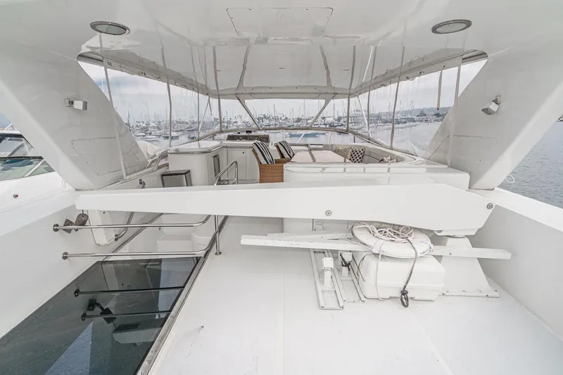 Slide: The Image of 1999 Horizon 70 Motor Yacht deck with seating and marina view. - 20