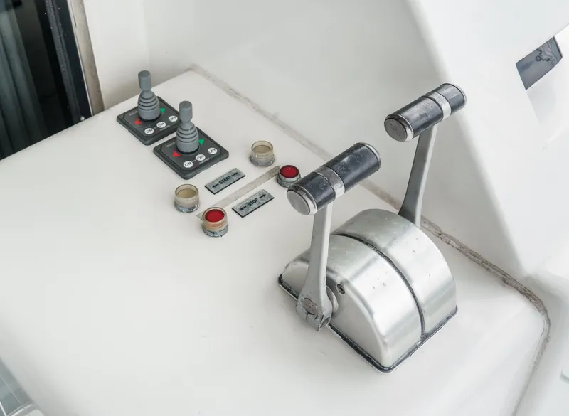 Slide: The Image of Control panel of a 1999 Horizon 70 Motor Yacht with levers and buttons. - 24