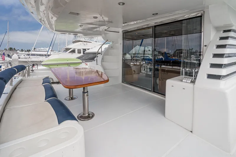 Slide: The Image of Outdoor seating area on a 1999 Horizon 70 Motor Yacht with marina view. - 25