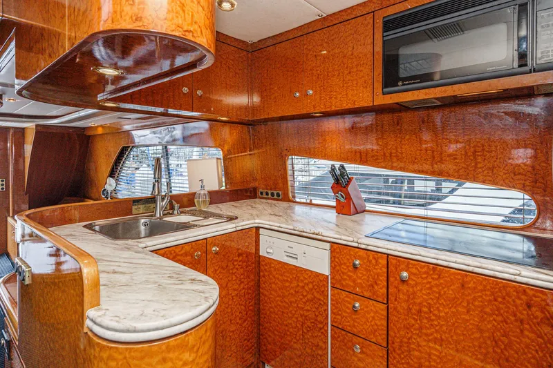 Slide: The Image of Luxurious kitchen interior of 1999 Horizon 70 Motor Yacht with wood finish and modern appliances. - 3