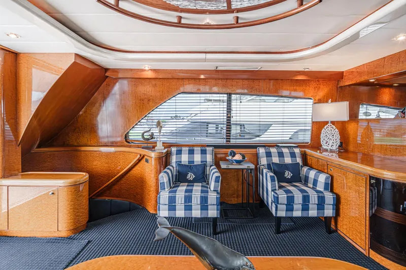 Slide: The Image of Luxurious interior of 1999 Horizon 70 Motor Yacht with striped chairs and elegant wood finish. - 31