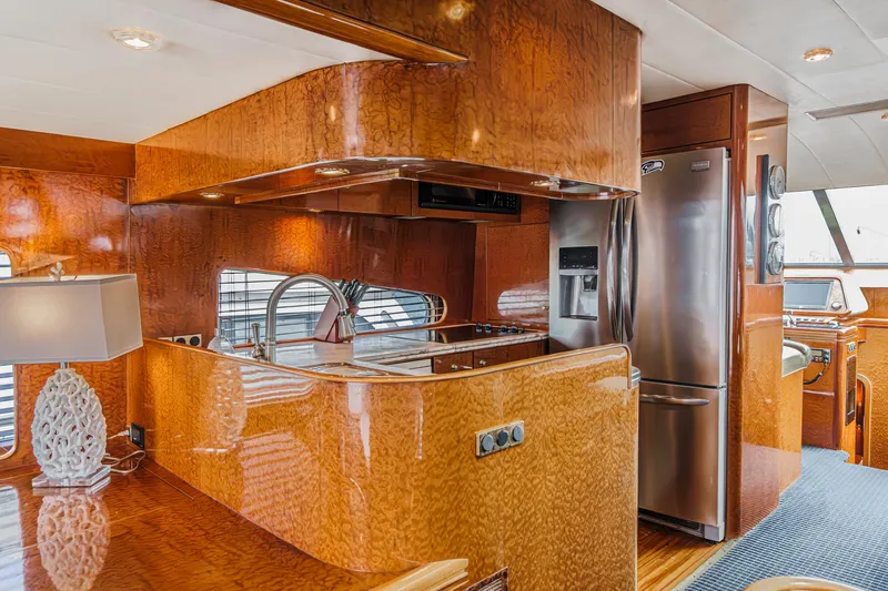 Slide: The Image of Luxurious kitchen interior of a 1999 Horizon 70 Motor Yacht with wood finish and modern appliances. - 33
