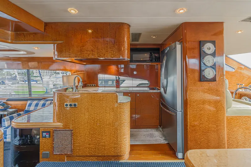 Slide: The Image of Luxurious kitchen interior of a 1999 Horizon 70 Motor Yacht with wood finishes and modern appliances. - 34