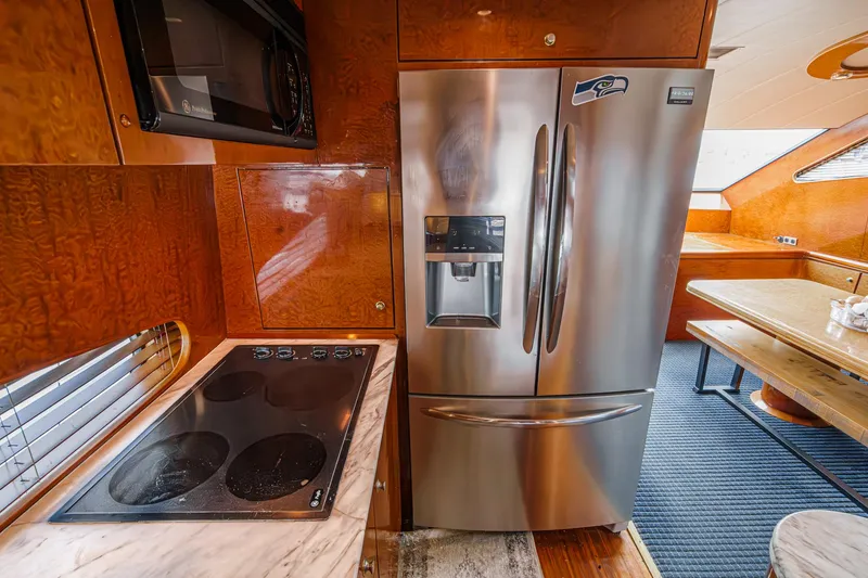 Slide: The Image of Luxurious kitchen in 1999 Horizon 70 Motor Yacht with stainless steel appliances and wood finish. - 37
